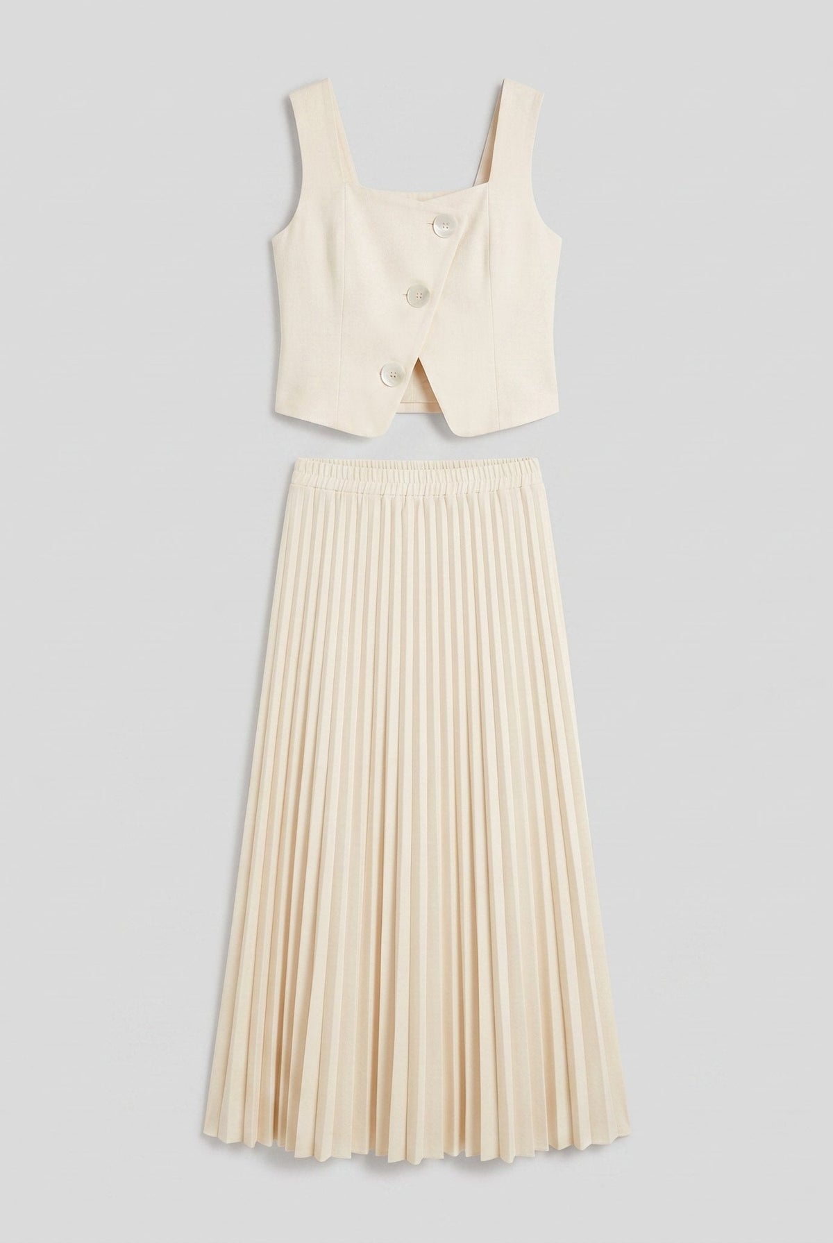 Sera Chic cream set flat lay, cropped waistcoat top and pleated maxi skirt