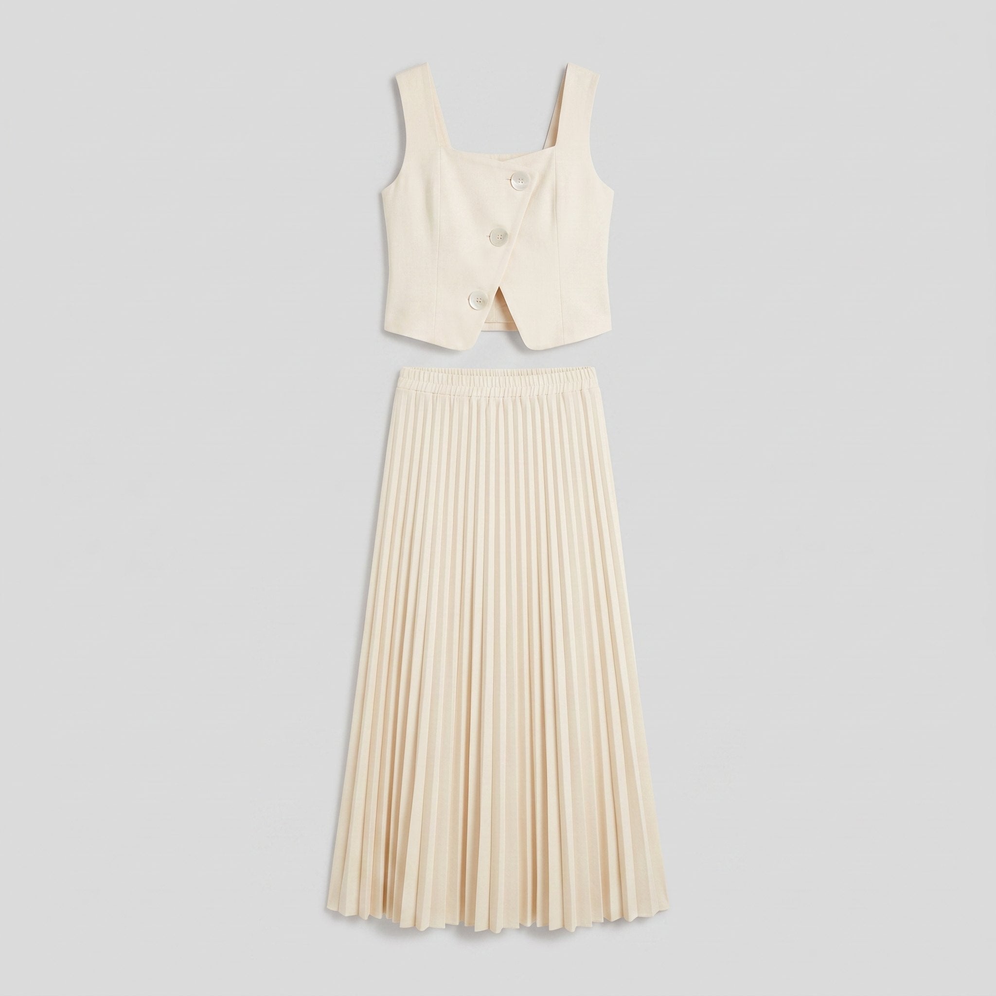 Sera Chic cream set flat lay, cropped waistcoat top and pleated maxi skirt