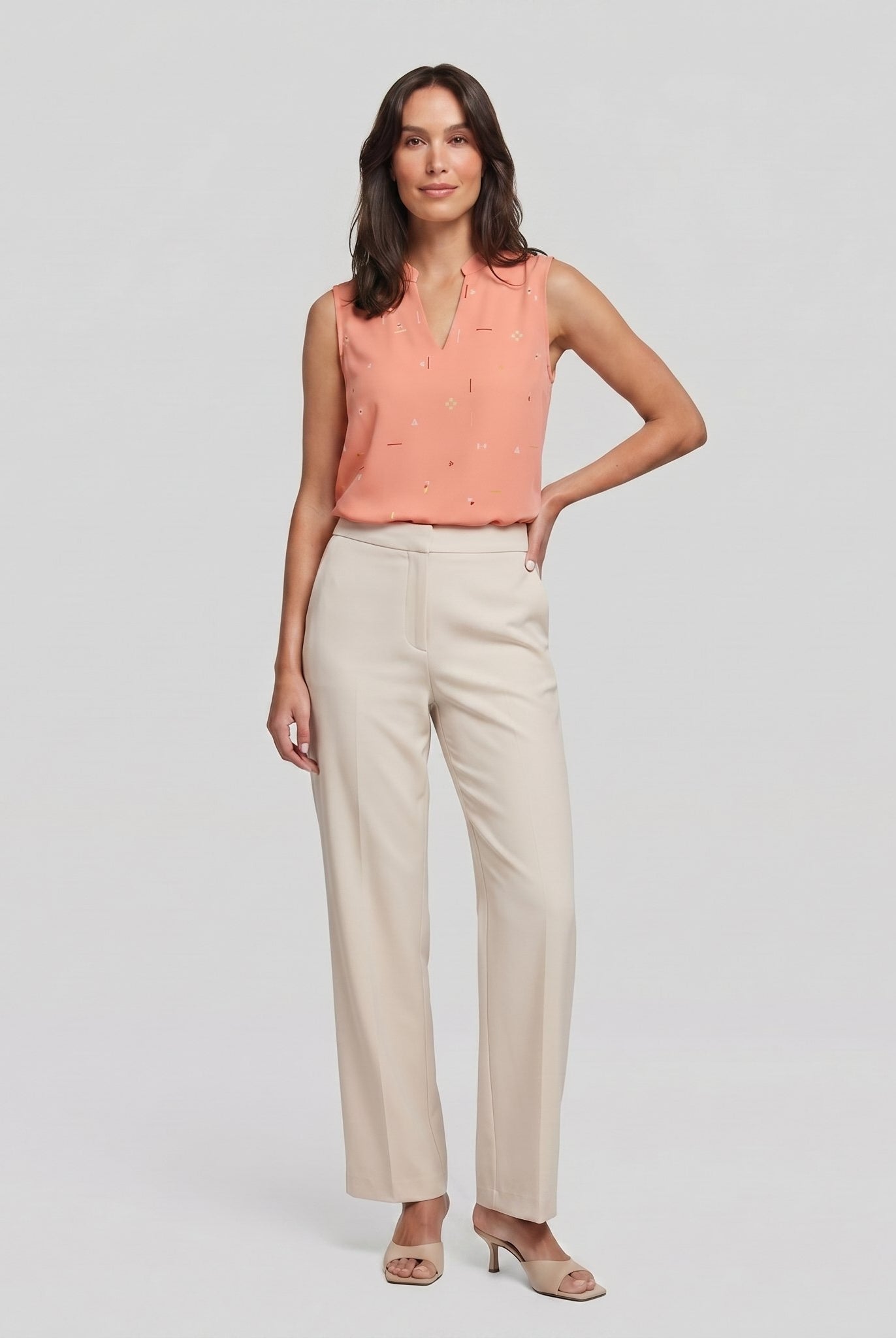 Pamela Boutique peach sleeveless V-neck blouse, model front view