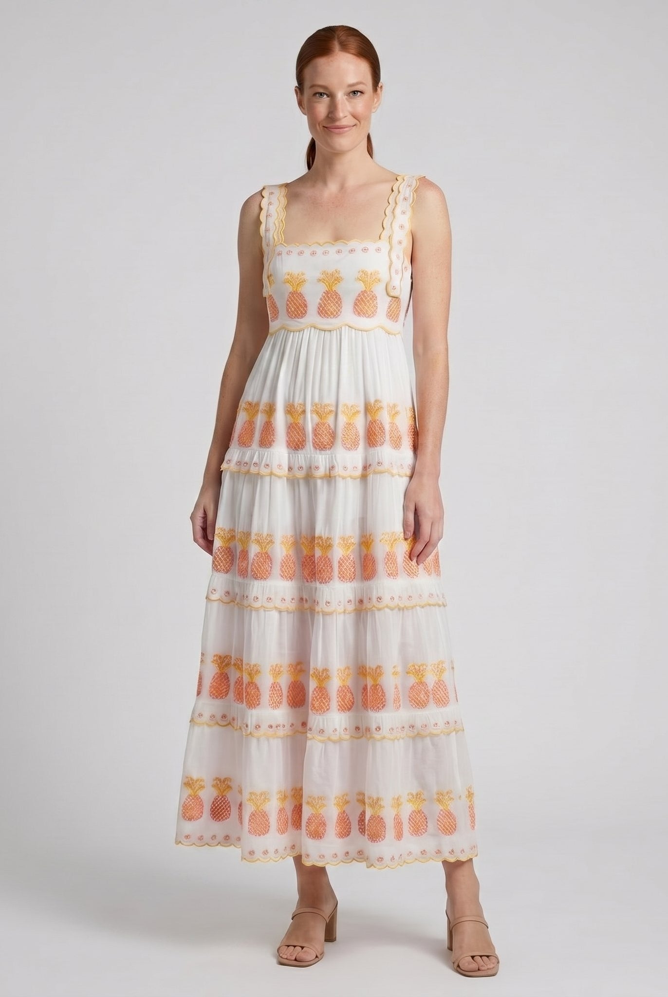 White square-neck tiered maxi dress, three-quarter view on model
