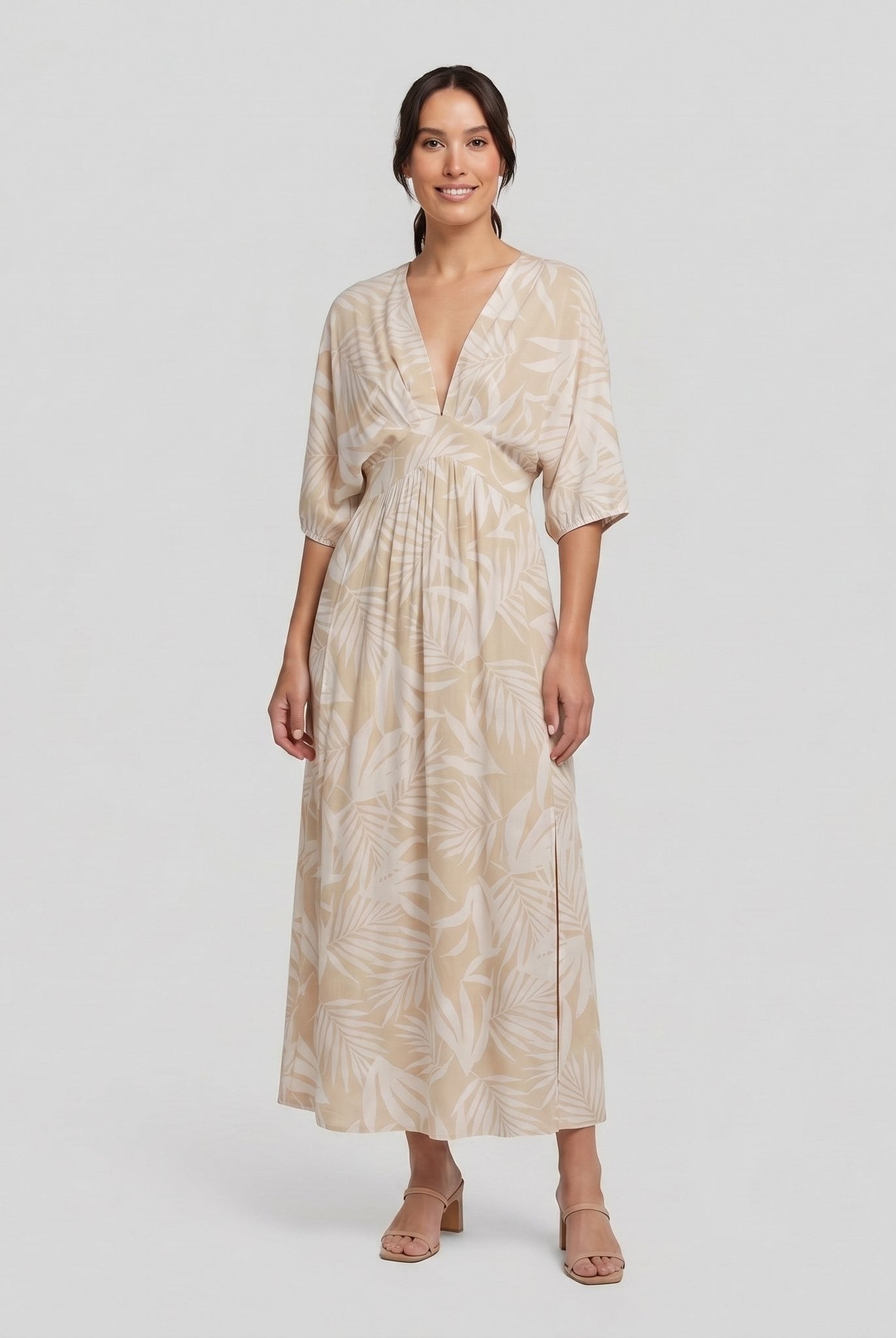 Beige tropical-print A-line maxi dress, three-quarter view on model