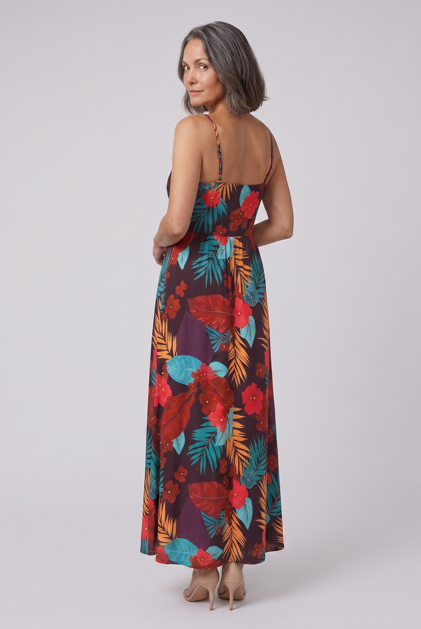 Vera maxi dress in floral print — back view, model glancing over her shoulder
