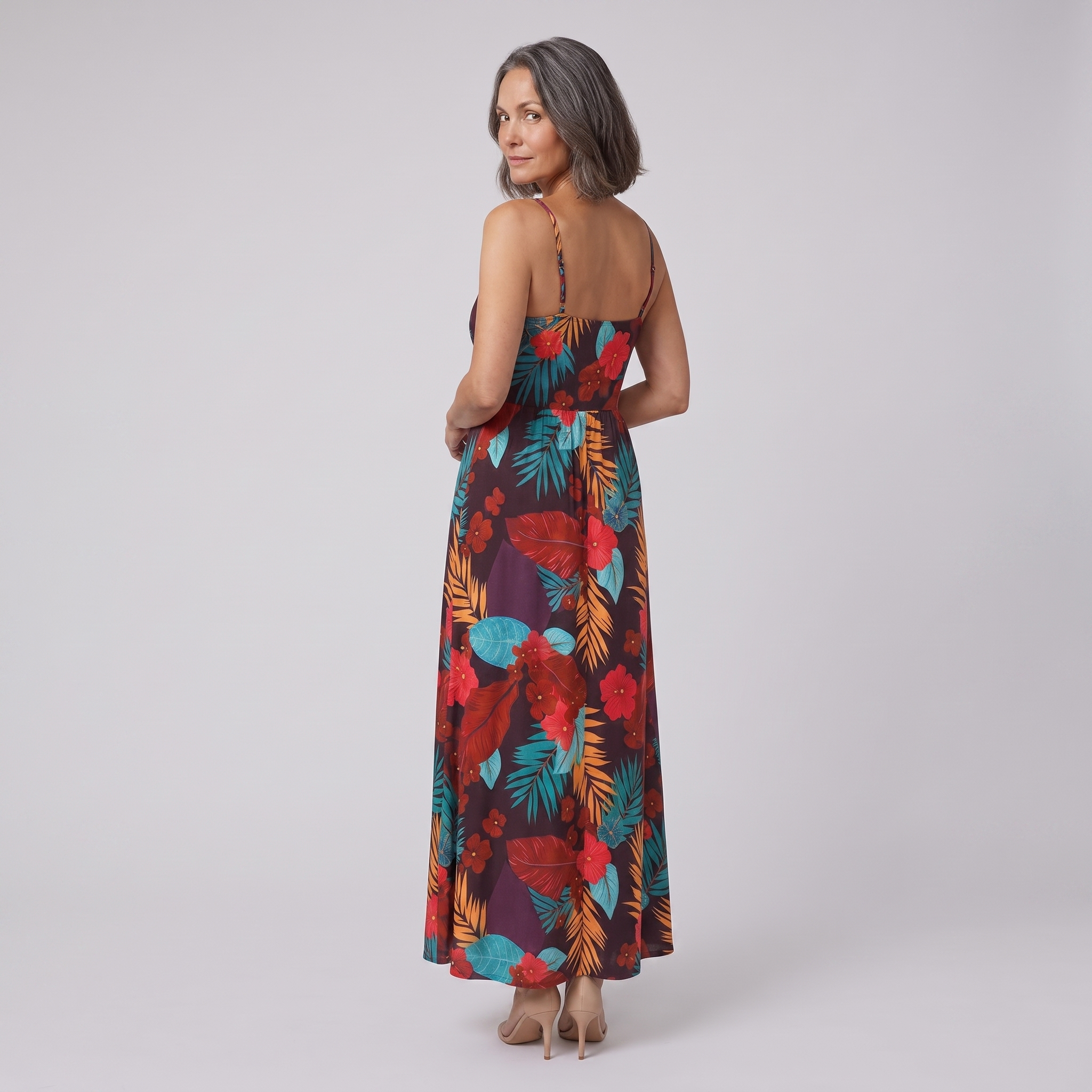 Vera maxi dress in floral print — back view, model glancing over her shoulder