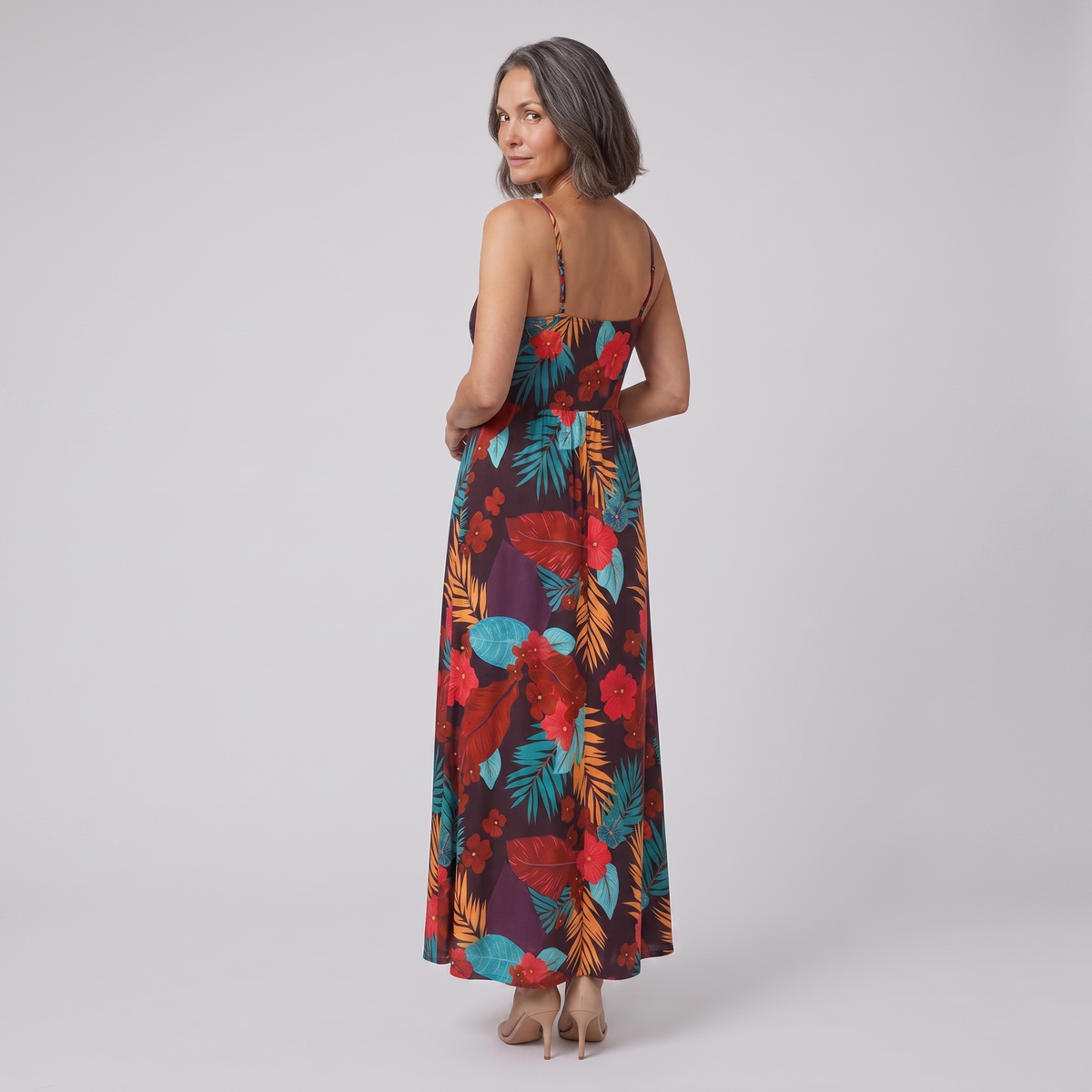 Vera maxi dress in floral print — back view, model glancing over her shoulder
