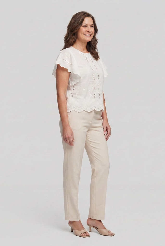 White broderie blouse with a scalloped hem, side view