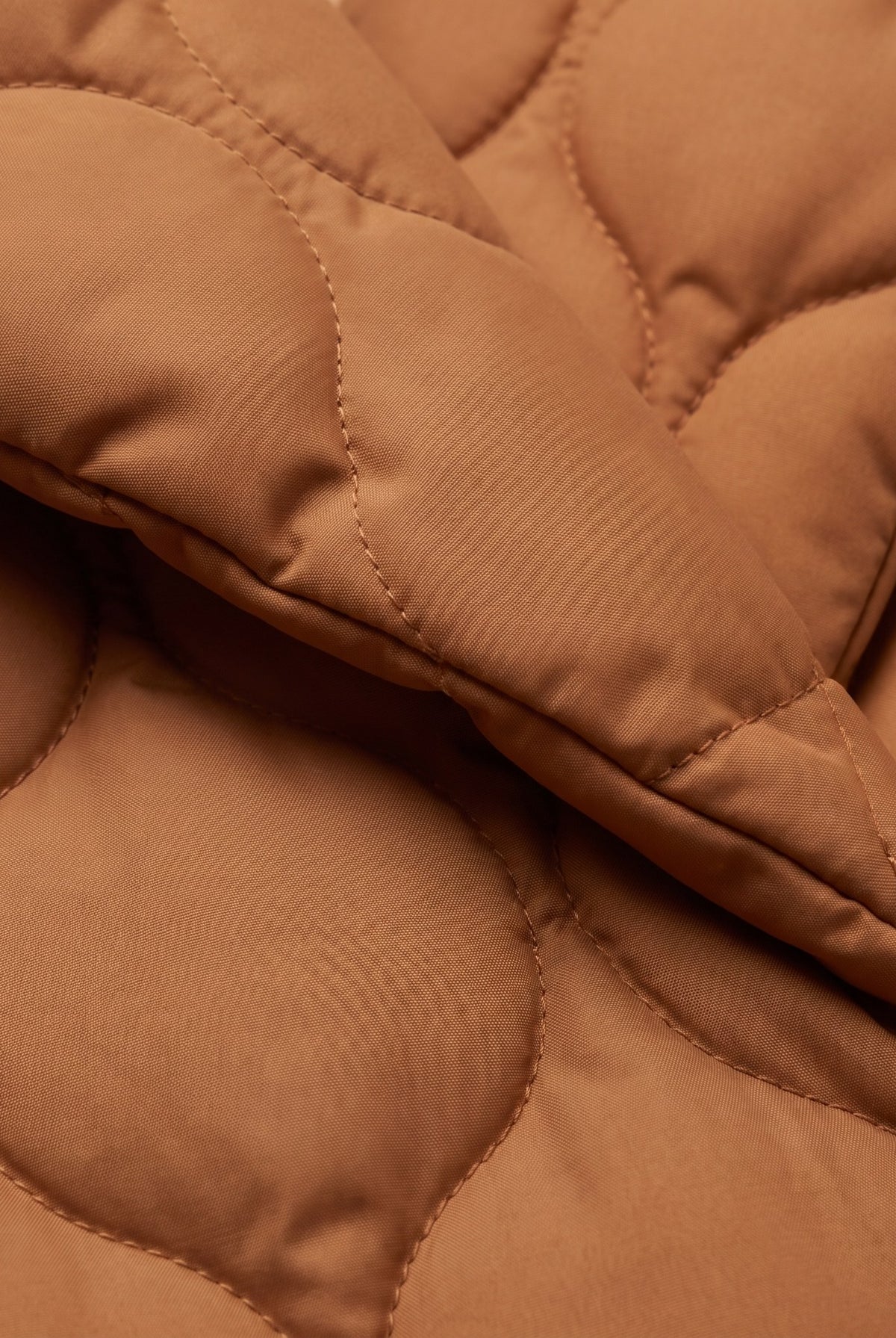 Ghislaine quilted jacket, close-up of the caramel pebble quilted fabric