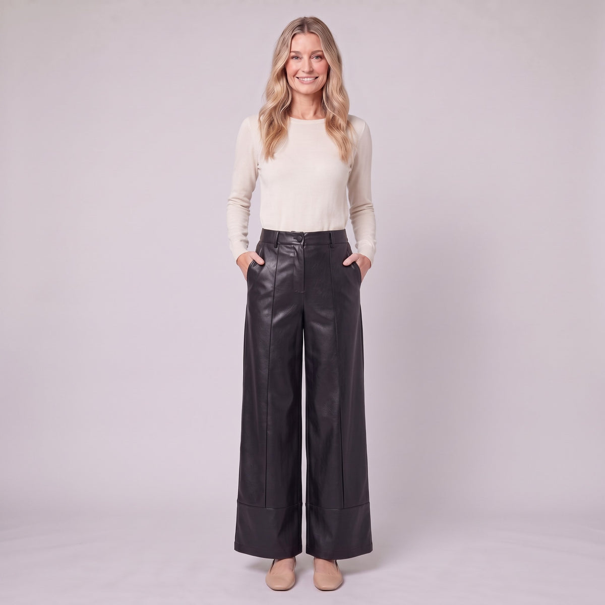 Helka faux leather wide leg trousers in black, full-length view with hands in the pockets