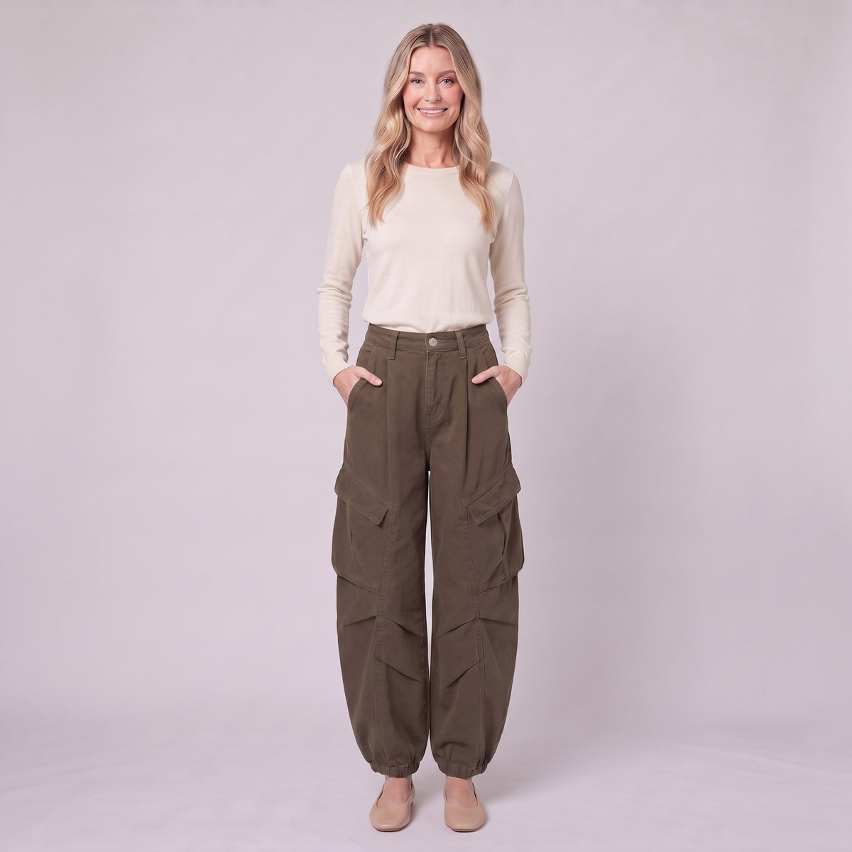 Inara baggy cargo trousers in dark olive brown, full-length view with hands in the pockets