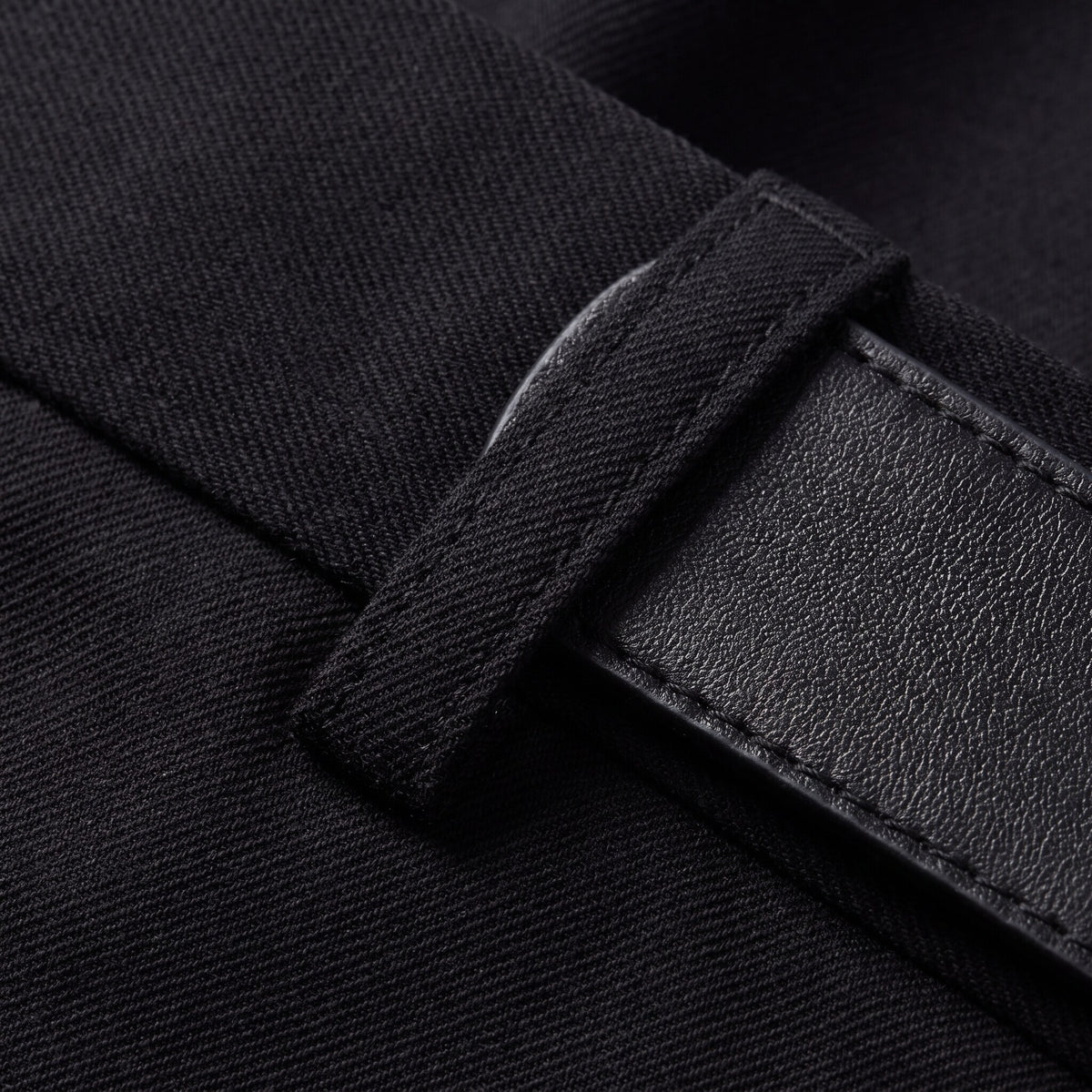 Ingeborg straight leg trousers fabric detail, black twill weave and leather belt close-up