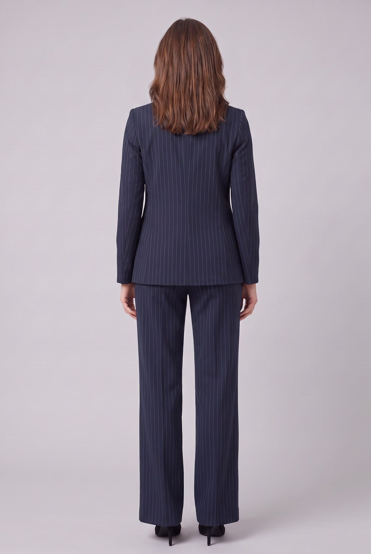 Iris navy pinstripe suit seen from behind, showing the blazer back and trouser drape