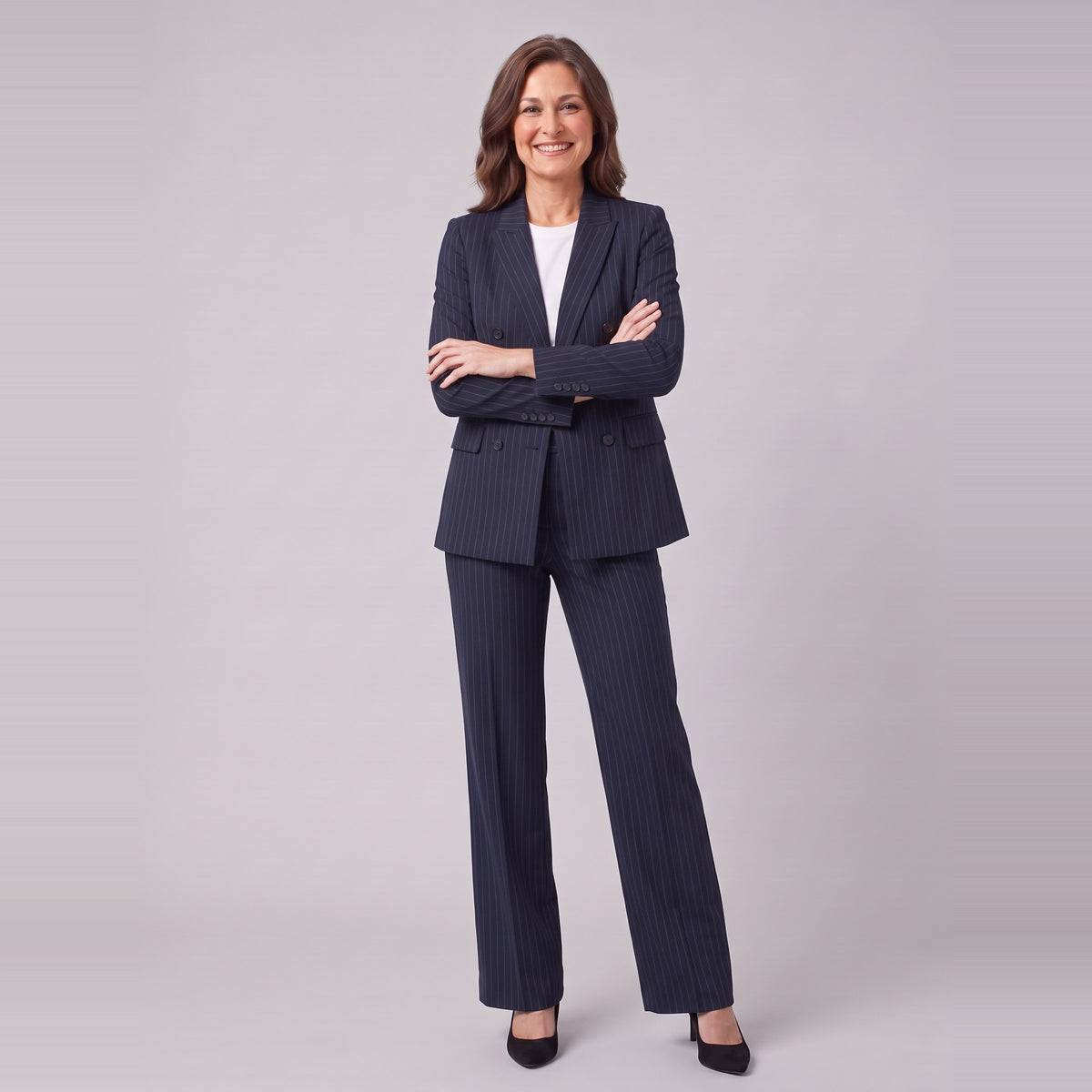 Iris navy pinstripe suit with arms crossed, standing view