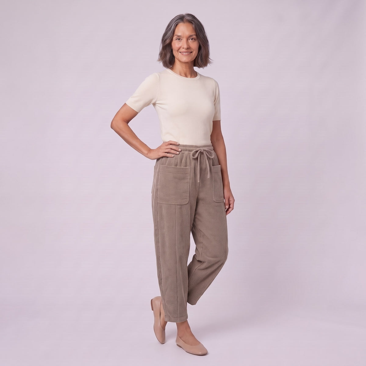 Kerensa barrel leg corduroy trousers in khaki taupe, three-quarter view showing barrel leg shape