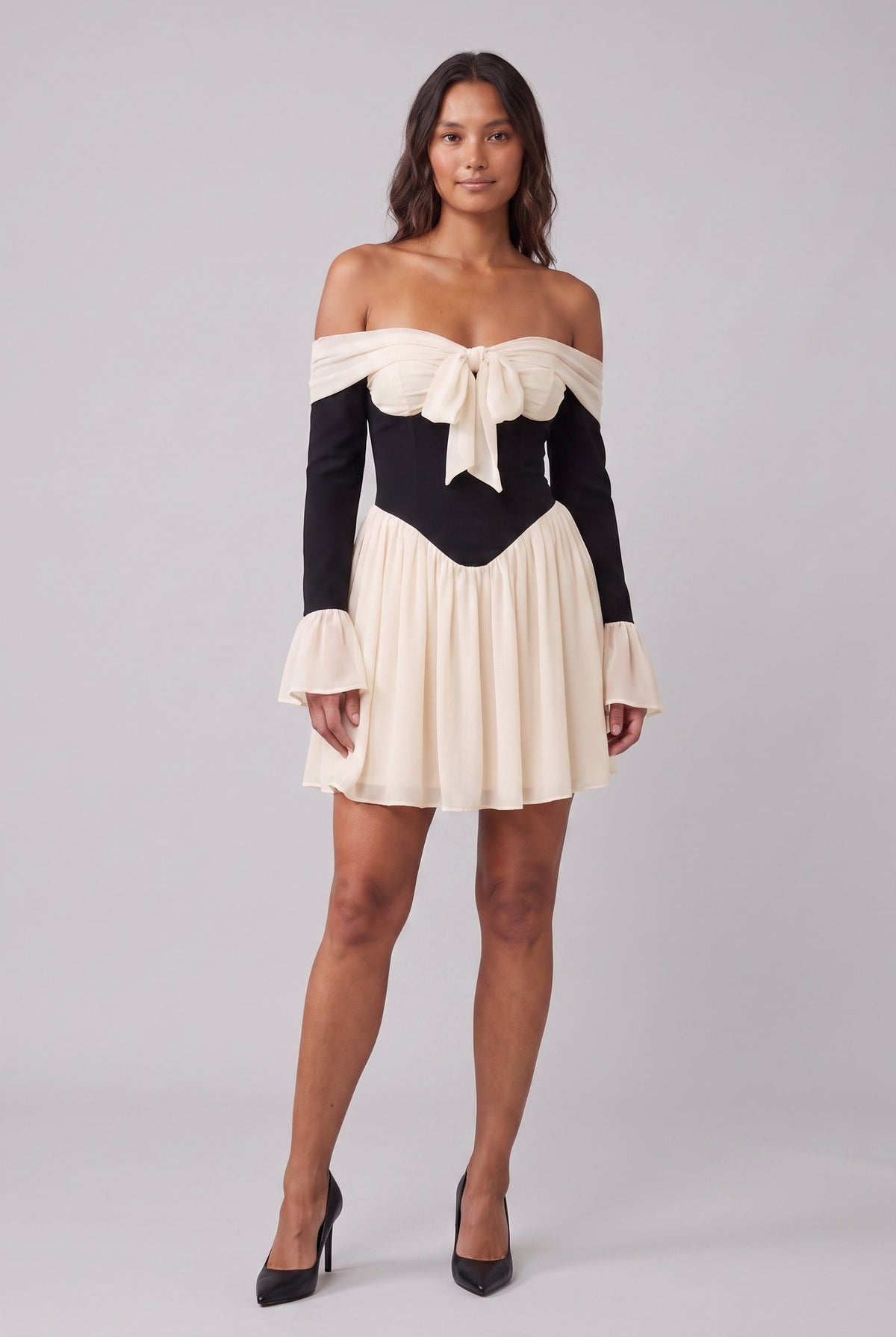 Odette off-shoulder corset mini dress in black with a cream bow at the bust, front view