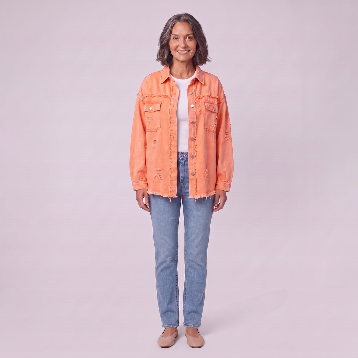 Saoirse distressed denim shacket in coral orange, front view on model