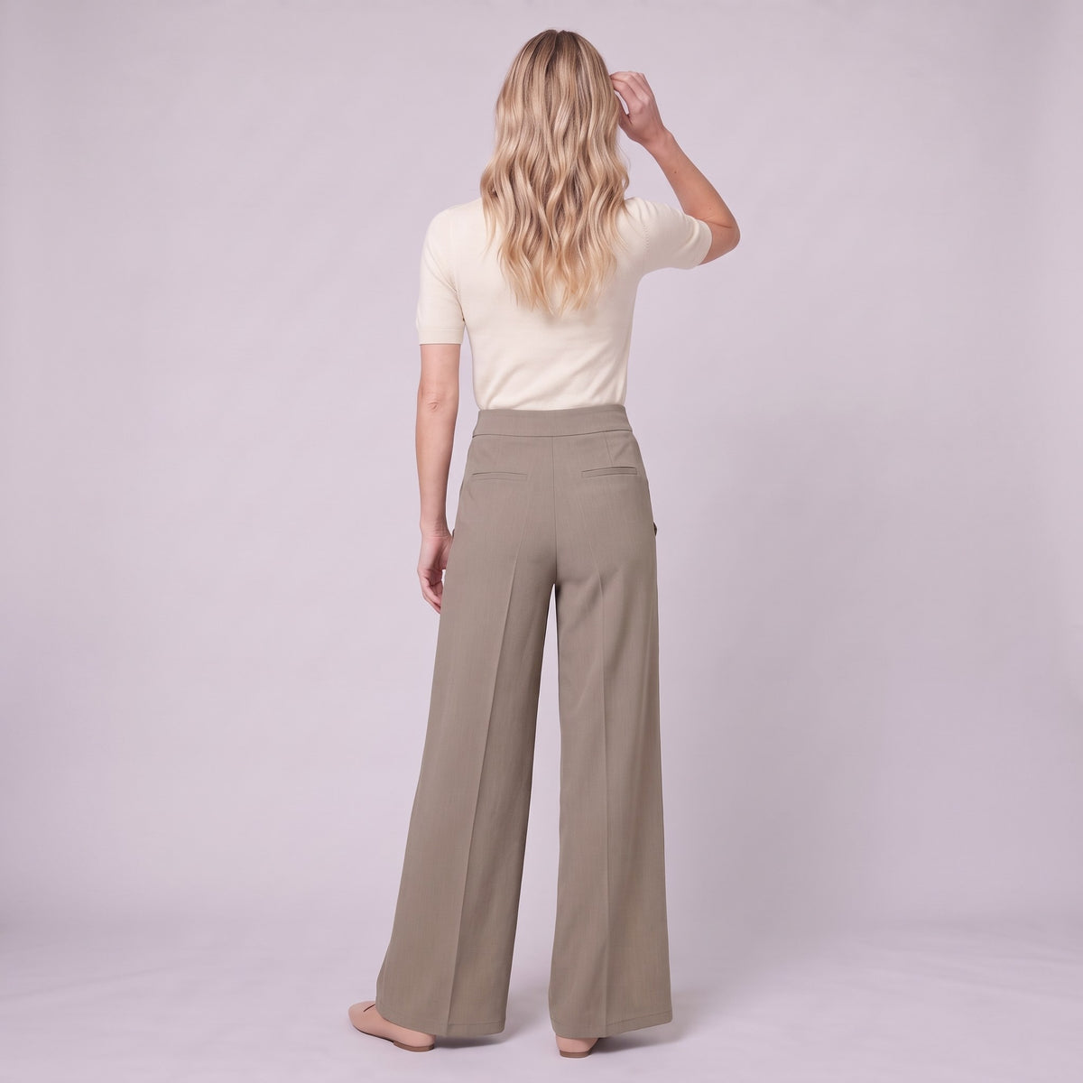 Valdis pleated wide leg trousers in taupe khaki, back view on model