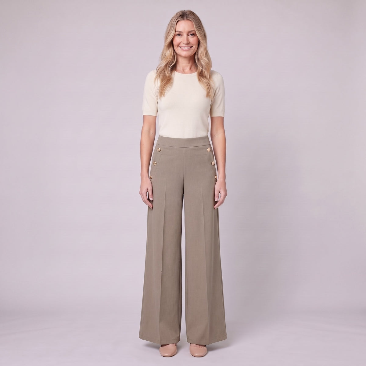 Valdis pleated wide leg trousers in taupe khaki with gold buttons, front view on model