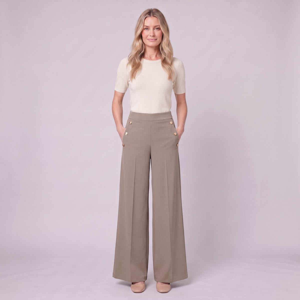 Valdis pleated wide leg trousers in taupe khaki, full-length view with hands in pockets