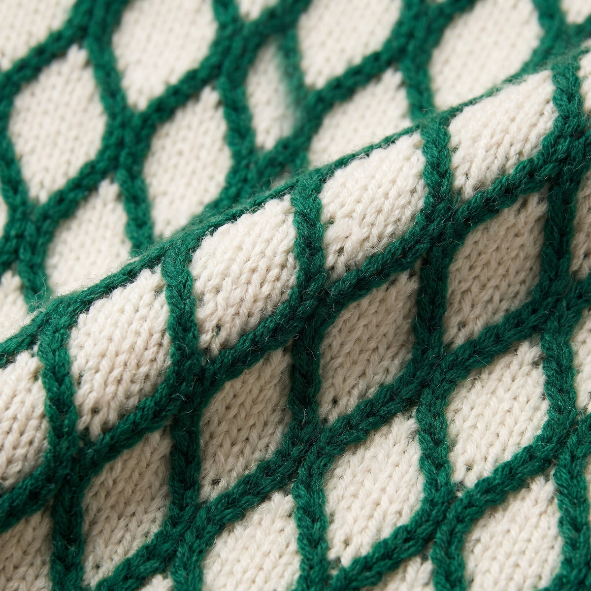 Zinnia lattice knit sweater in emerald green, close-up of the diamond lattice knit