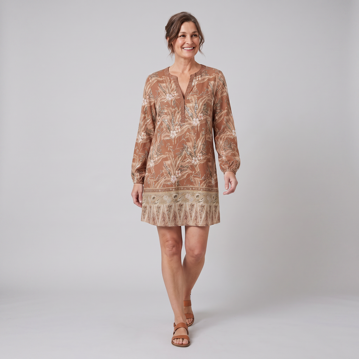 Brown floral shift mini dress, walking pose on model, grey studio background