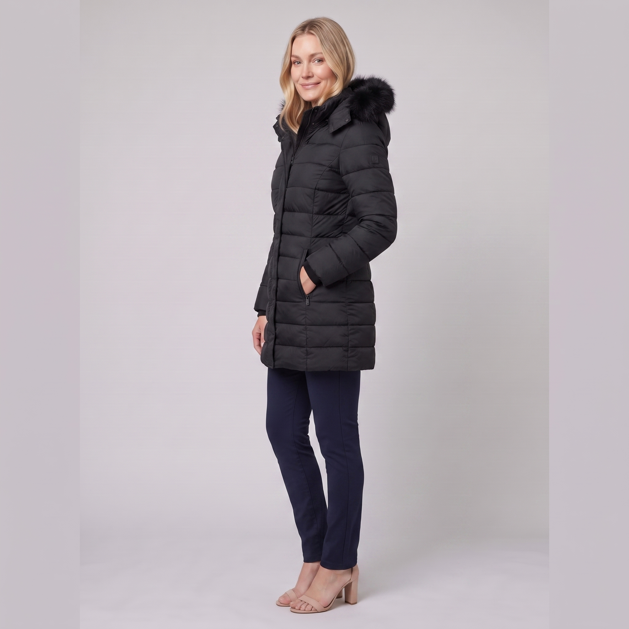 Evara lightweight hooded puffer jacket in black, side view on model