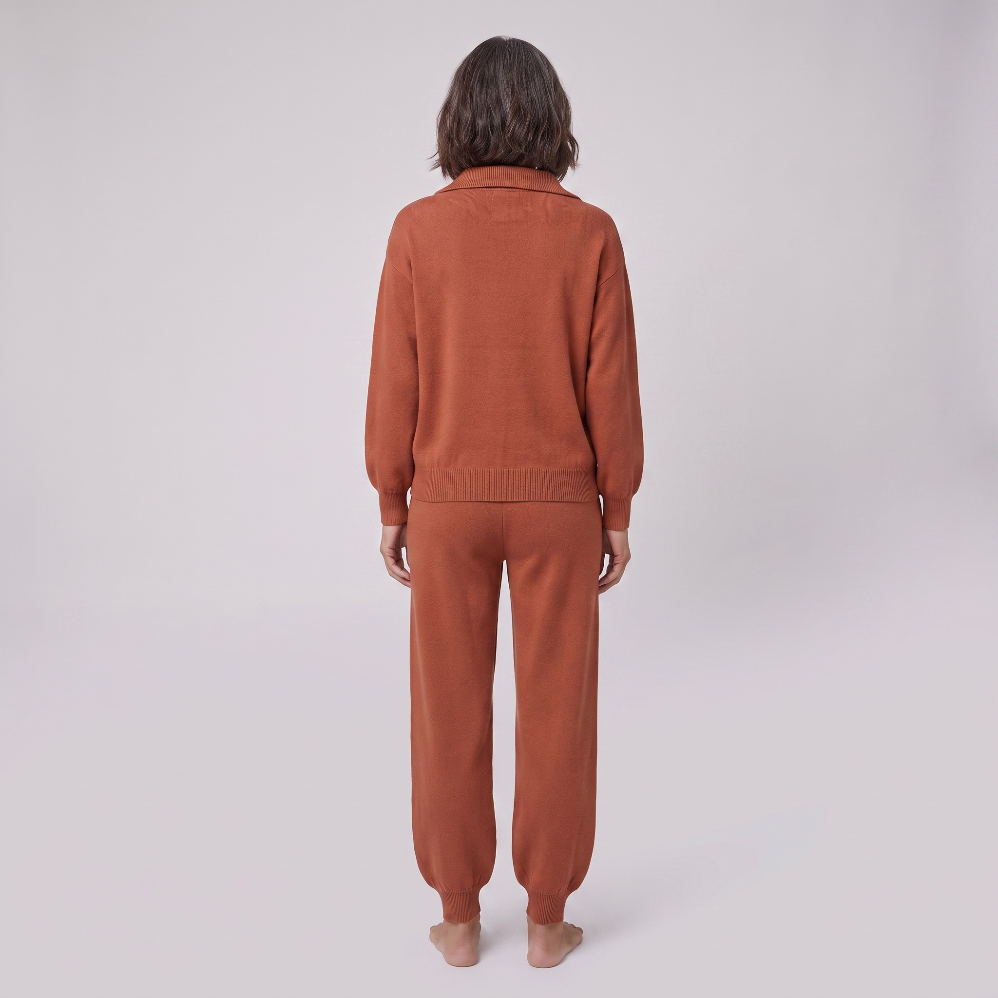 Fjorda half-zip knit lounge set in rust, back view on model