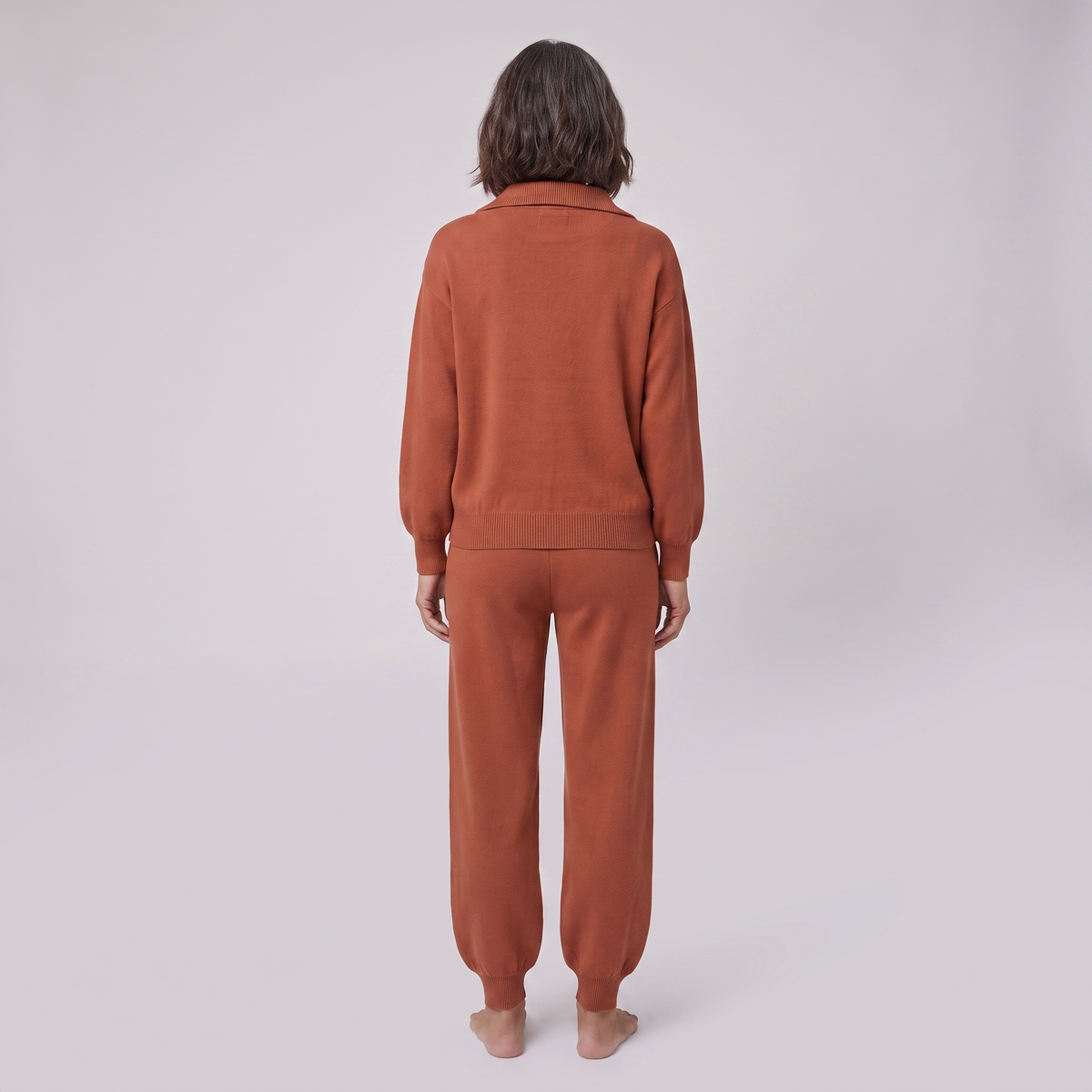 Fjorda half-zip knit lounge set in rust, back view on model