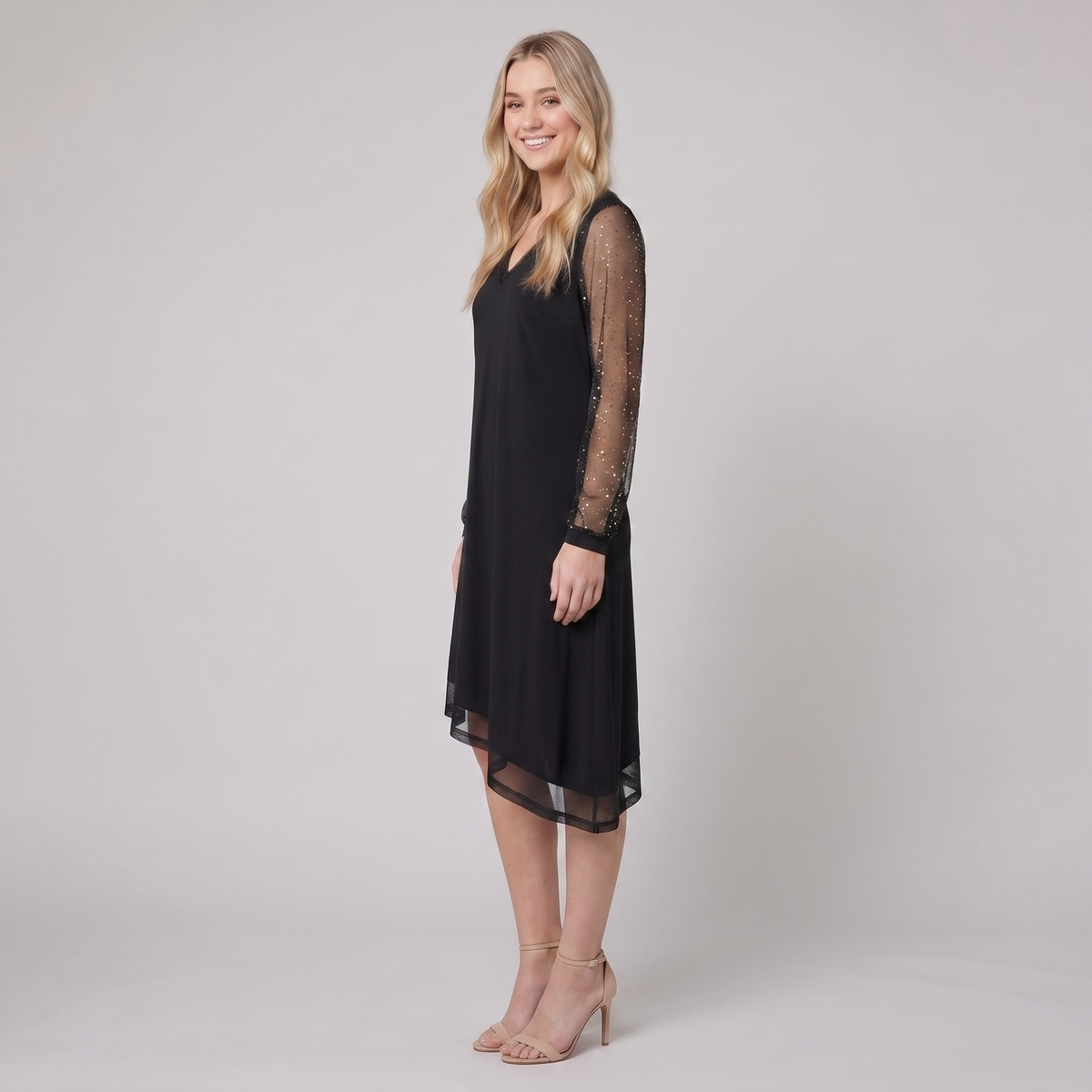 Genevieve sheer sleeve evening dress in black, side view on model