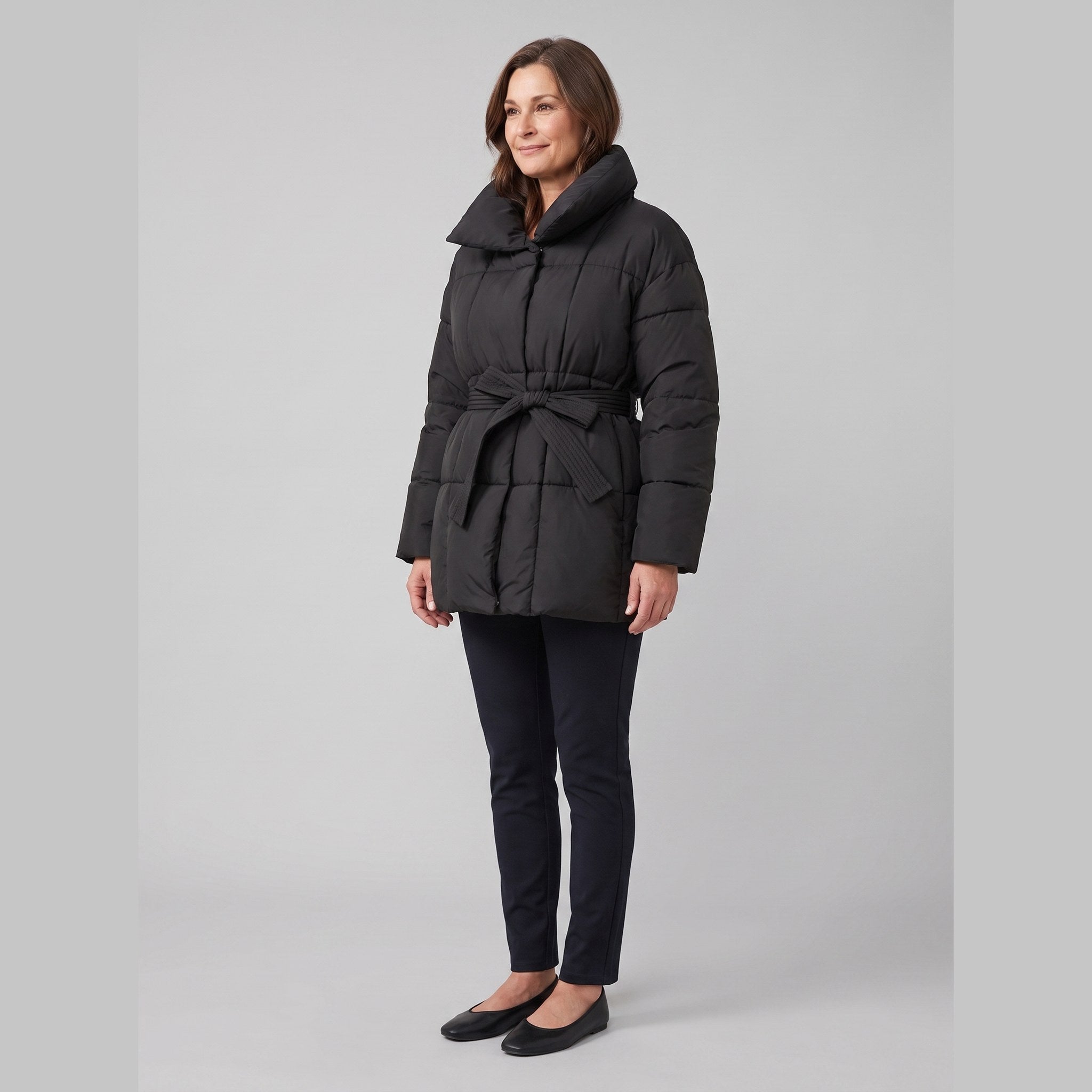 Haven belted puffer coat in black on model