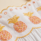 White embroidered pineapple maxi dress fabric close-up detail