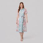 White A-line collared midi dress, walking pose on model