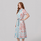 White collared midi dress with belt, three-quarter side view on model