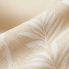 Tropical leaf print fabric close-up detail, beige cream base with green pattern