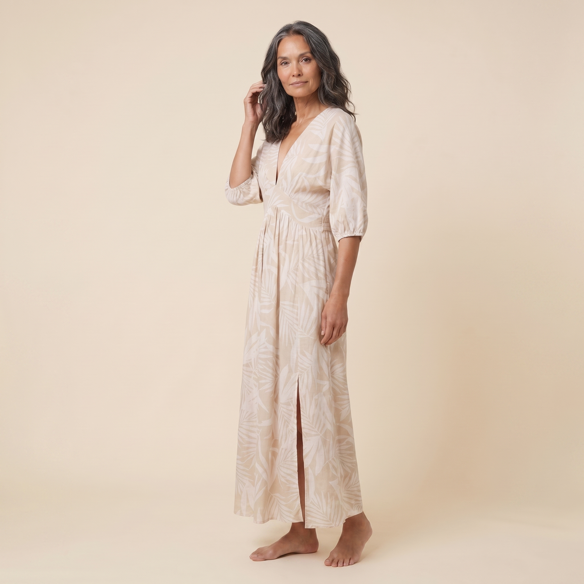 Beige tropical print A-line maxi dress, three-quarter side view on model
