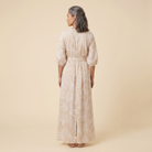 Beige tropical print maxi dress, back view on model showing silhouette