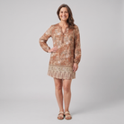 Women's brown floral V-neck long-sleeve shift mini dress, front view on model, grey studio background