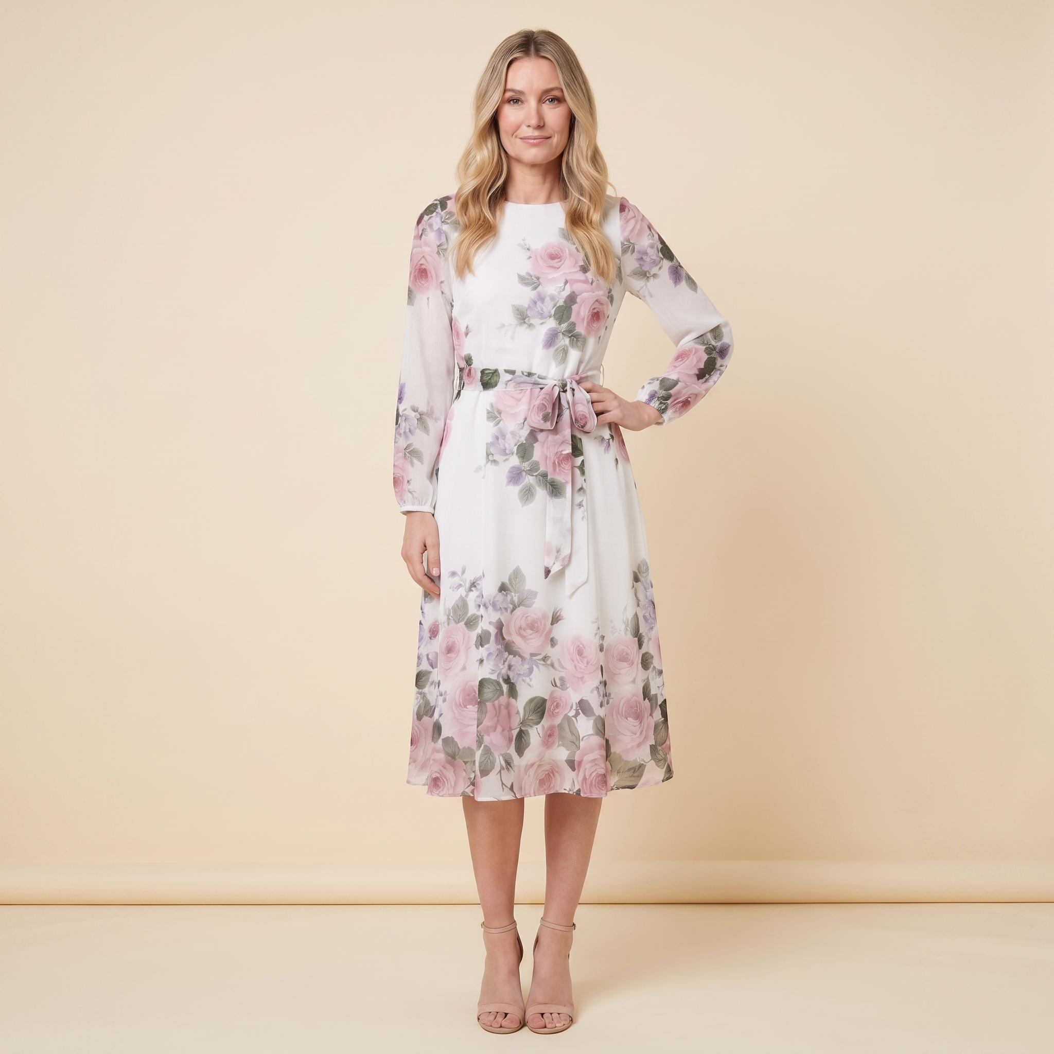 Model wearing white floral A-line midi dress with tie belt, front pose hand on hip