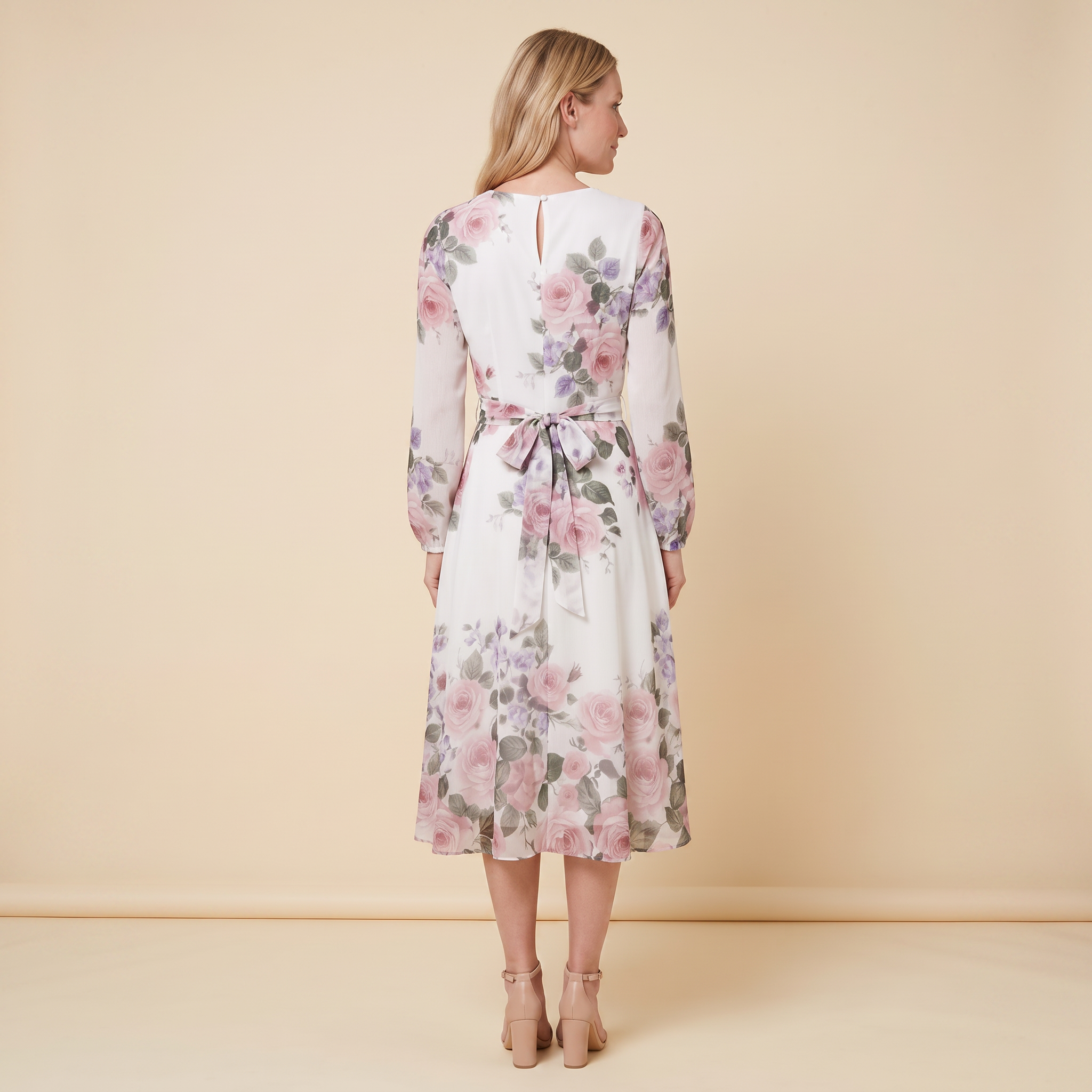Model wearing white floral A-line midi dress with tie belt, back view