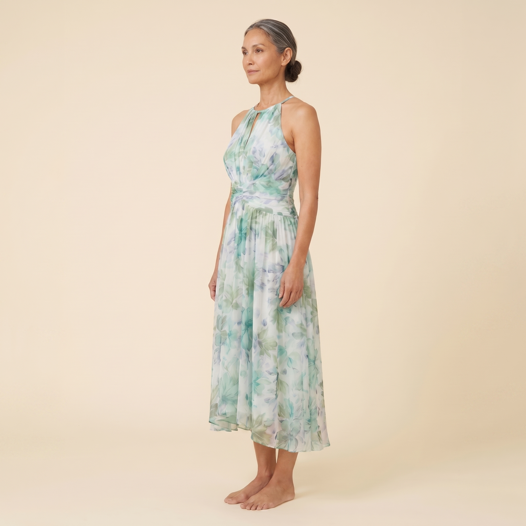 Poppy Dress green floral halter midi side angle on model