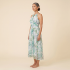 Poppy Dress green floral halter midi side angle on model