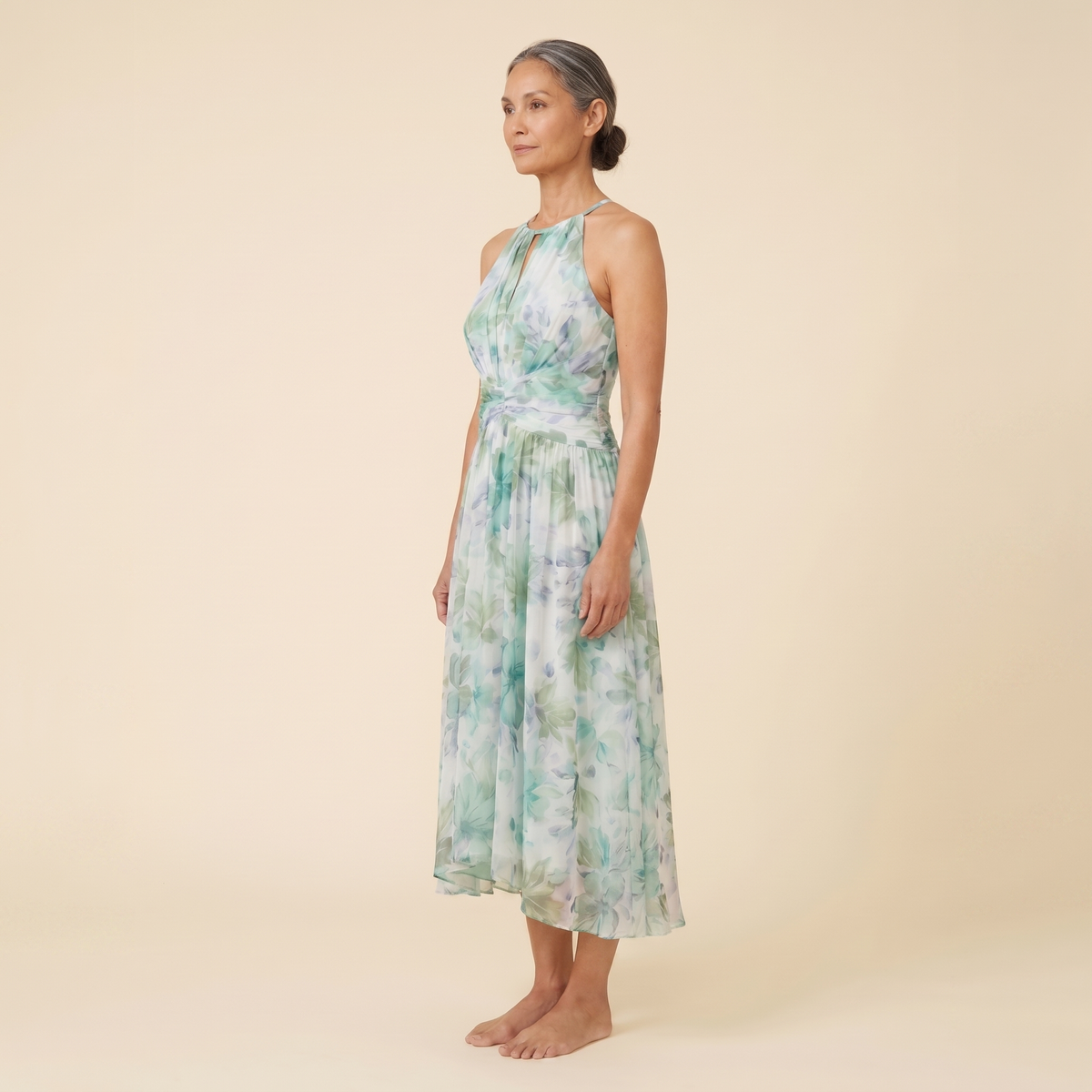 Poppy Dress green floral halter midi side angle on model