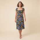 Ivy Summer Dress black floral print walking pose on model