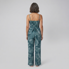 Teal wide-leg jumpsuit with smocked bodice, back view on model
