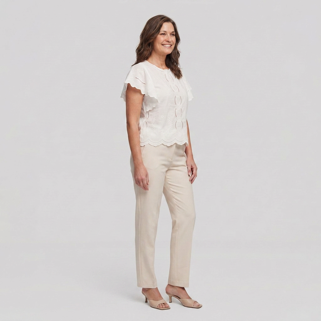 Pamela Boutique white broderie anglaise blouse flutter sleeve, model side view