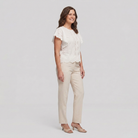 Pamela Boutique white broderie anglaise blouse flutter sleeve, model side view