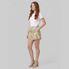 Pamela Boutique beige floral A-line shorts, model side view