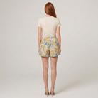 Pamela Boutique beige floral A-line shorts, model back view