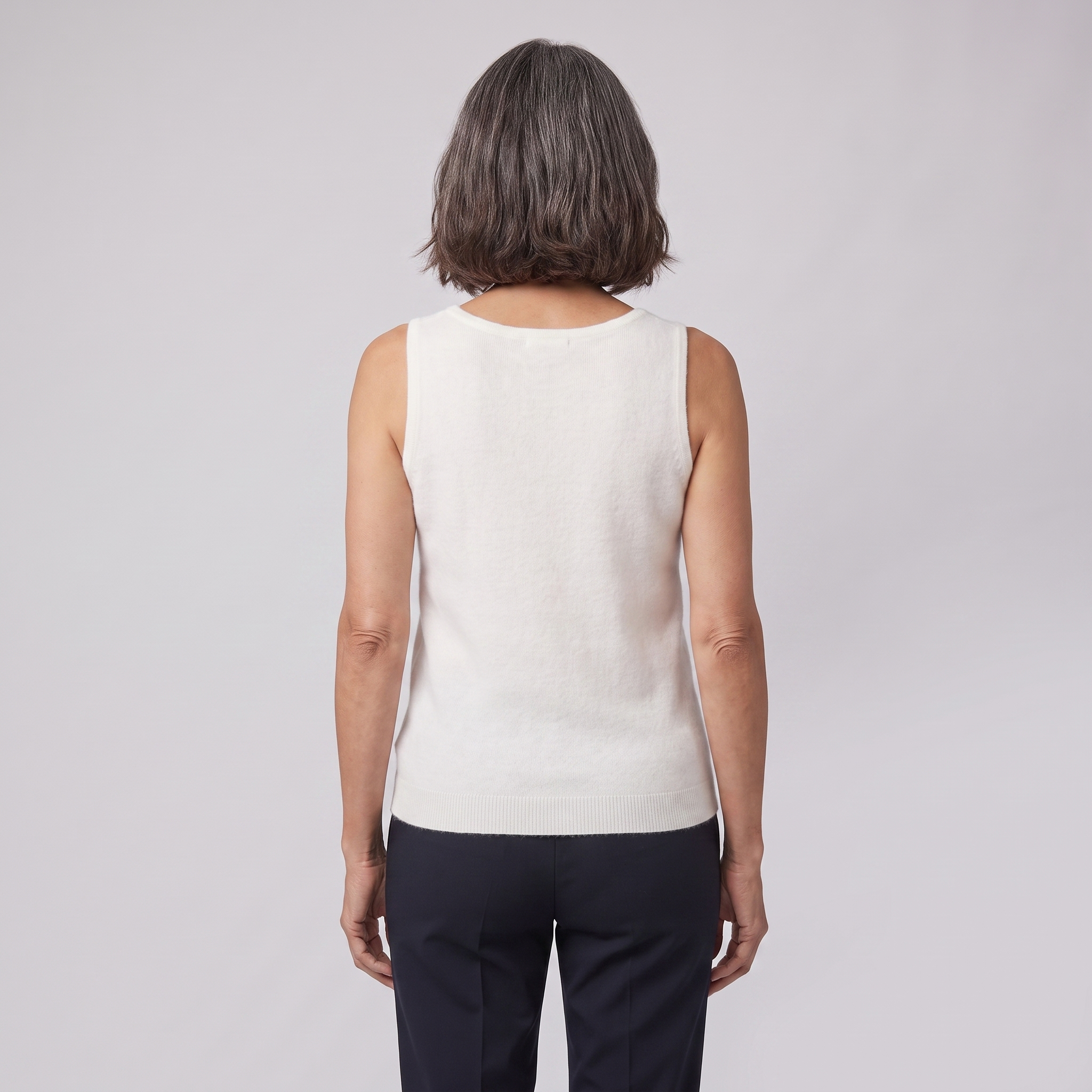 Ivanna sleeveless knit vest in ivory, back view on model