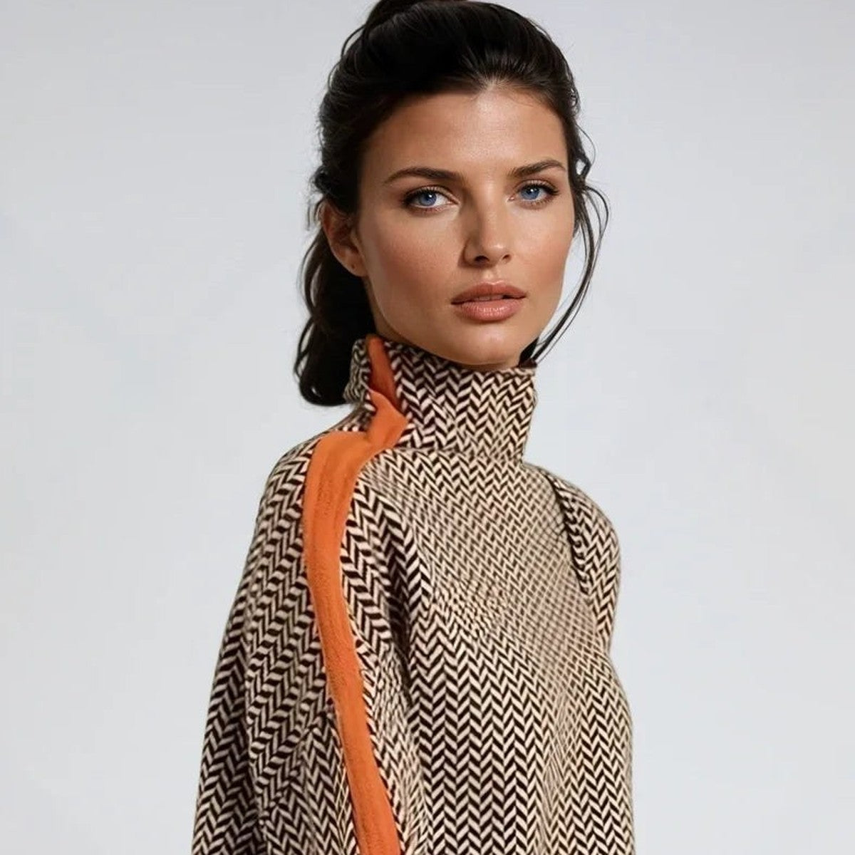 Close-up of women's taupe and orange contrast stripe roll neck