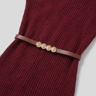 Liora turtleneck dress leather belt and rib texture close-up