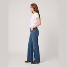 Maren wide-leg jeans in mid blue, side view on model
